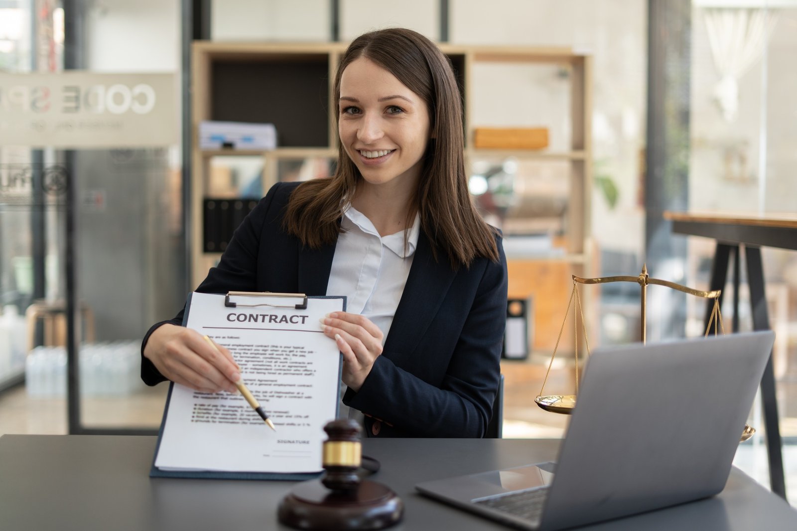 Woman lawyer working on a laptop. Legal law, advice and justice concept.