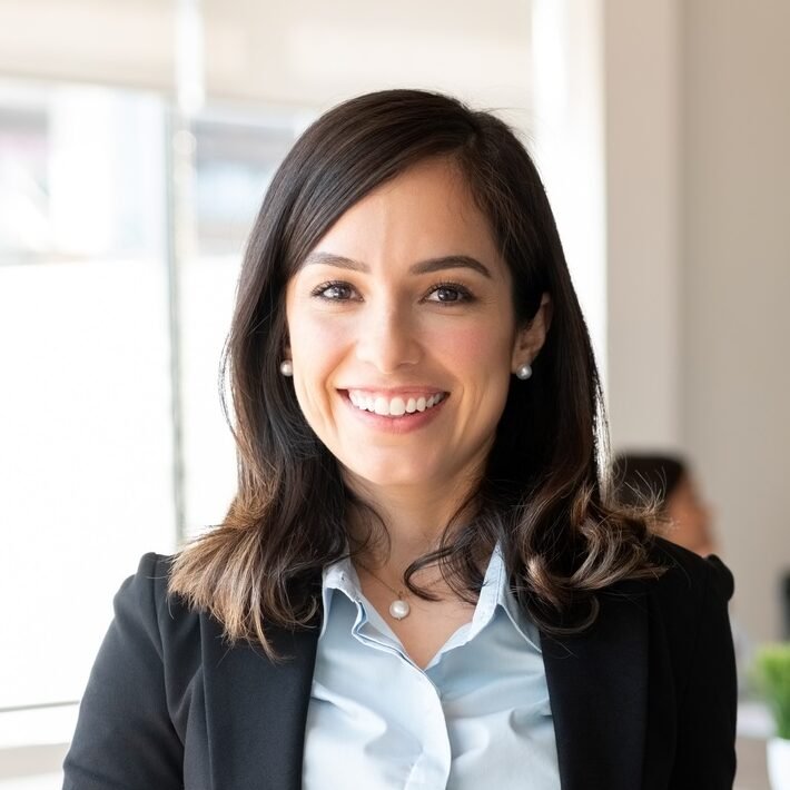 Smiling female entrepreneur with laptop in a meeting room