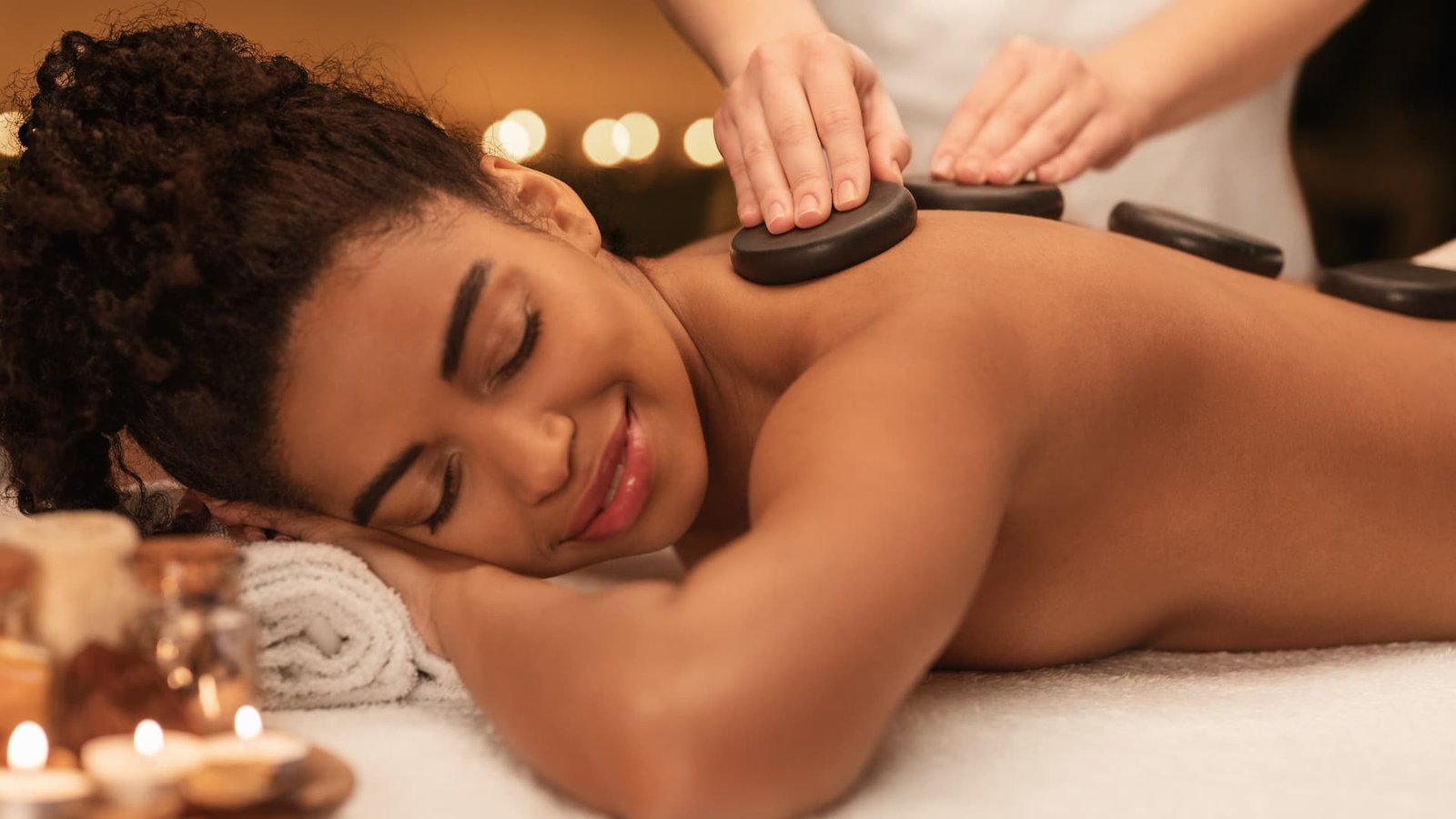 african-lady-receiving-professional-hot-stone-9EV9EZR